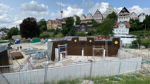 Bild einer Baustelle. Zu sehen sind geschalte und bereits betonierte Wände, im Hintergrund die Leonberger Altstadt.
