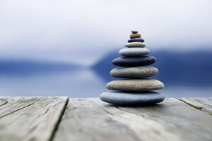 Zen Balancing Pebbles Next to a Misty Lake